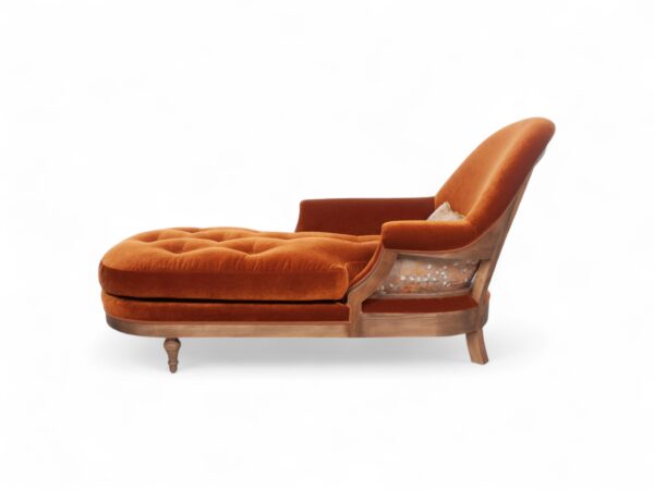 Side view of Opulent Orange Chaise Lounge showcasing its curved high backrest