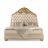 Regal high-back headboard with ornate carved crest in gold finish