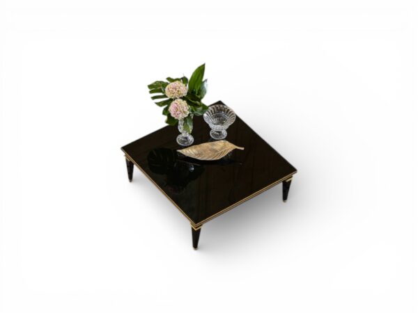 Designer table with tapered legs and gold tips