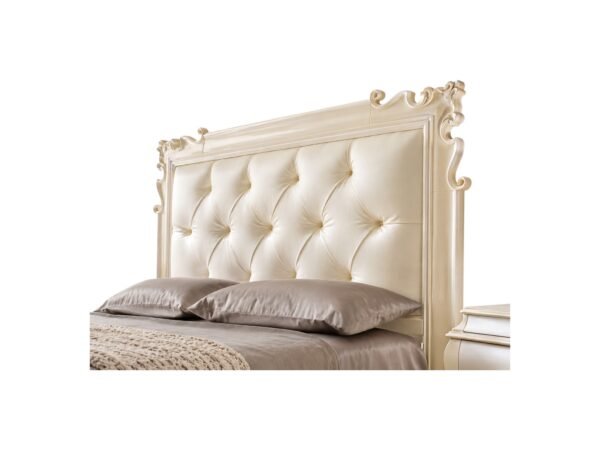 Elegant master bedroom bed with carved detailing