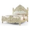 Grand sculpted wooden bed with ornate detailing