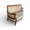 Elegant wicker back sofa with jade floral upholstery
