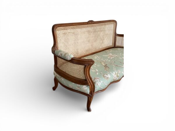 Elegant wicker back sofa with jade floral upholstery