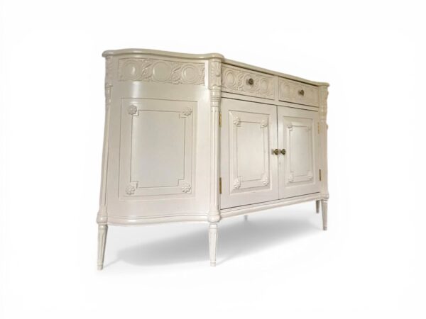 Elegant wedge sideboard with carved detailing